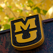 MU sign with fall leaves in background