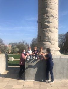 A photo of students and educators at the Columns.