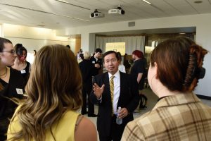 A photo of President Choi speaking to students at the Chancellor's Leadership Class poster presentations.