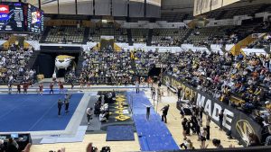 A photo of a Mizzou Gymnastics team member in front of an excited crowd at the Hearnes Center.