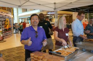 A photo of President Choi serving at the staff recognition lunch.
