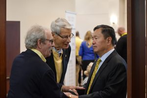 A photo of Douglas Ghertner and Larry McMullen with President Choi.