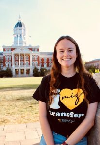 A photo of Emma Fassler, an MU transfer student and TEAM Student Executive Board member, showing the Transfer Week shirt.