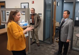 A photo of Christine Even with John Middleton and President Choi in the Counseling Center.
