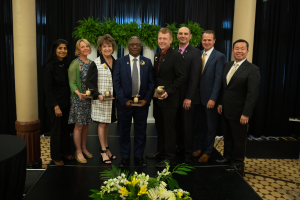 A photo of (Left to right) Provost Ramchand, 2023 Kemper Fellows Lea Ann Lowery, Beth Whitaker, David Mitchell, Christopher Josey and Lee Manion, along with Steve Sowers (CEO of Missouri Community Markets for Commerce Bank) and President Choi.