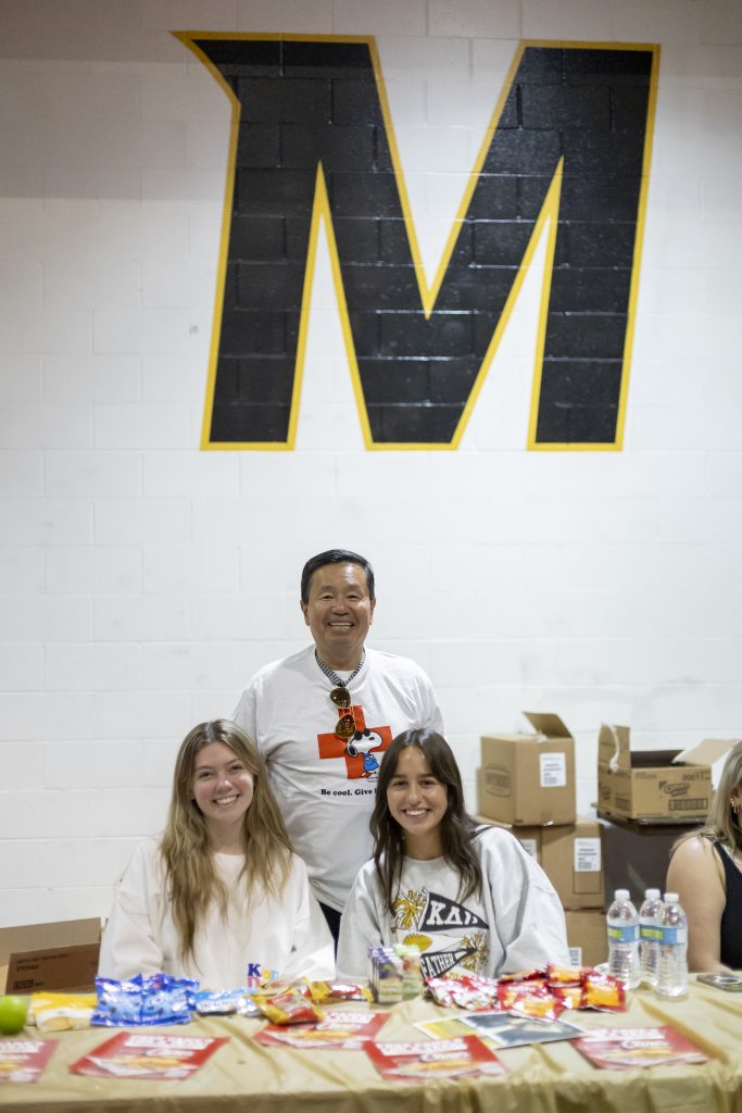 A photo of President Choi at the Homecoming Blood Drive with student volunteers Ainsley Joynt, freshman (left) and Carrie Wagenknecht, sophomore (right).