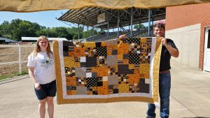 Julianna Gardner with her Mizzou quilt and Landon Bax, MU Extension field specialist in 4-H Youth Development. 