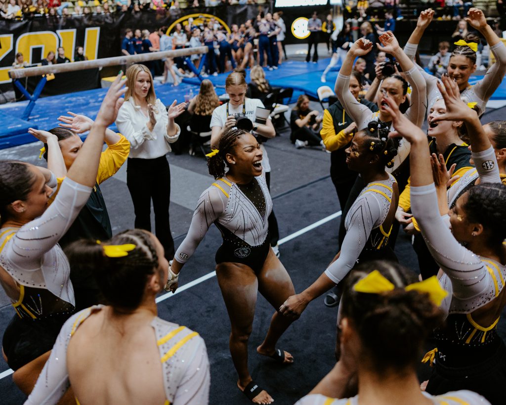 Tiger teammates cheer for senior Jocelyn Moore during their meet against No. 13 Auburn. 