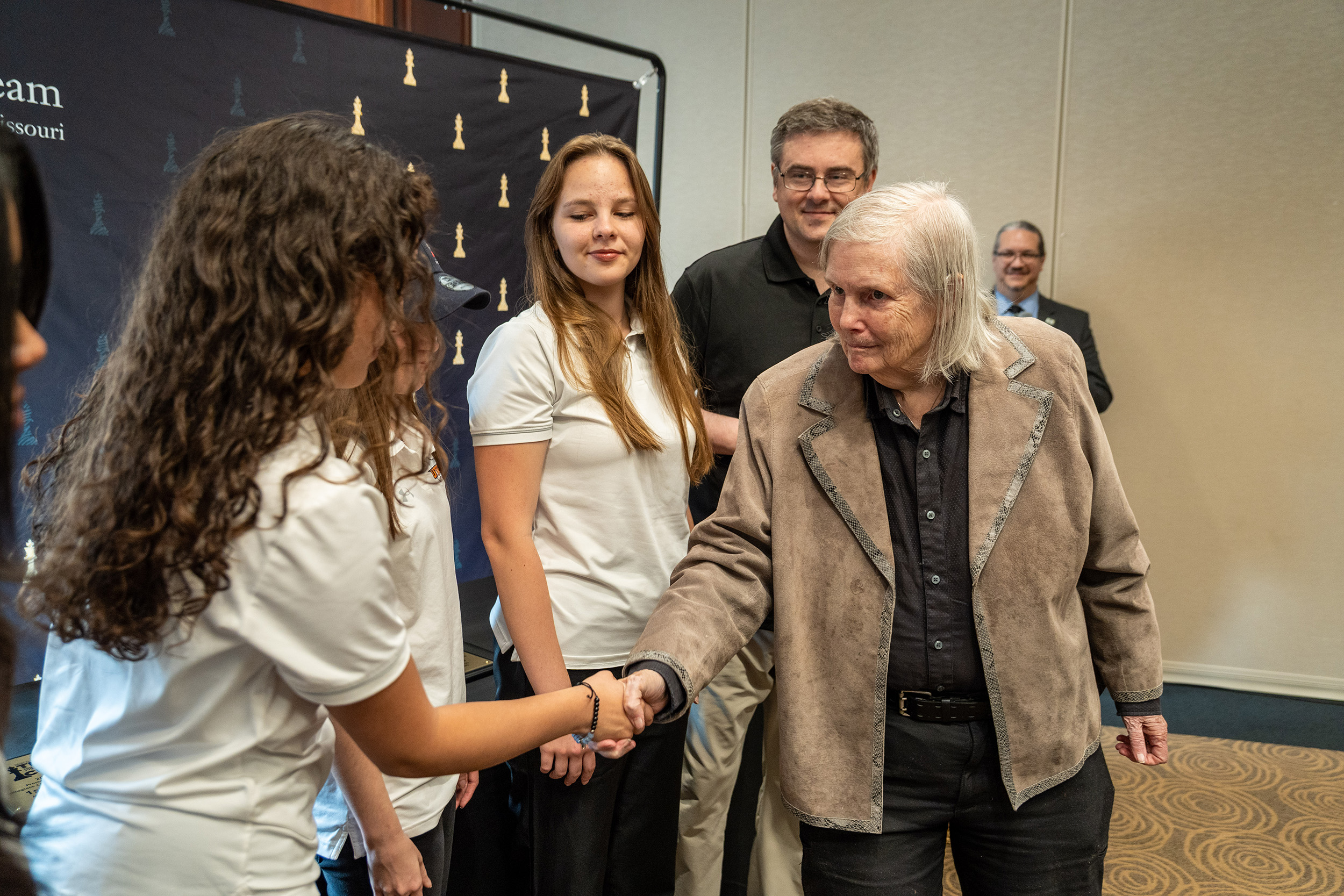 Curator Jeanne Cairns Sinquefield congratulating participants