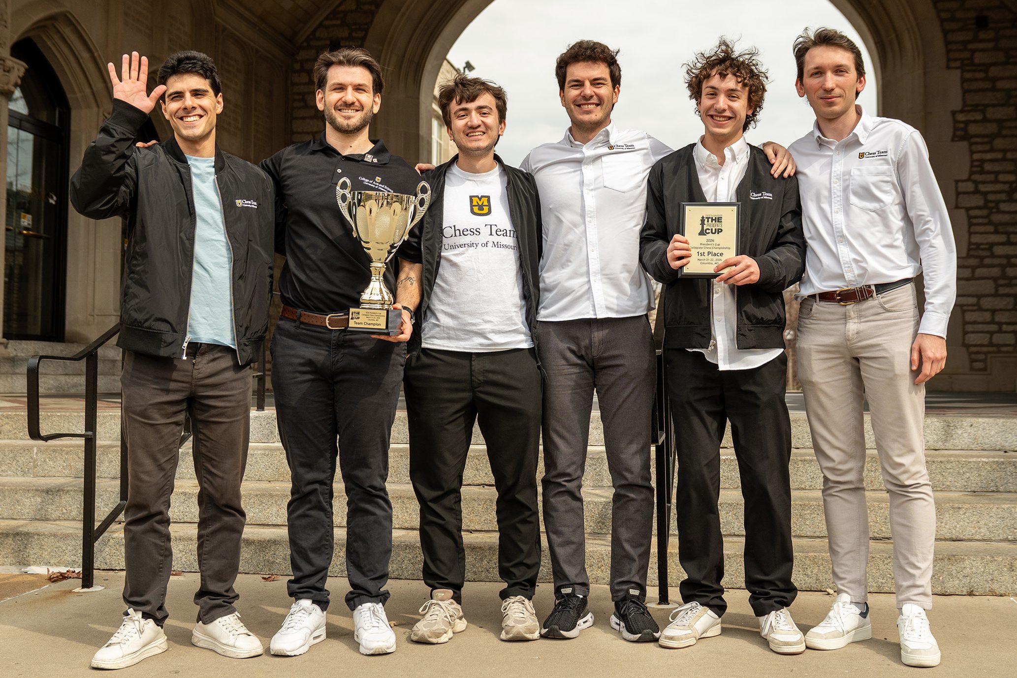 Aryan Tari, Head Coach Cristian Chirilă, Isik Can, Luka Budisavljević, Mahel Boyer and Grigory Oparin in front of the archway at Memorial Student Union